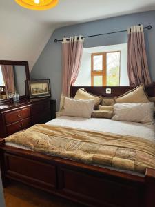 a bedroom with a large bed and a window at Stone Lodge B&B in Balrath
