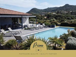 a villa with a swimming pool and lounge chairs at A GIOIA DI CAMPA in Figari