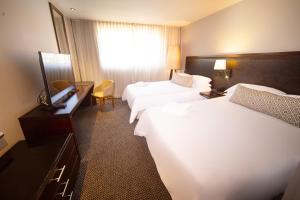 Ένα ή περισσότερα κρεβάτια σε δωμάτιο στο Movich Hotel Las Lomas
