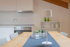 a kitchen with a table with a lamp on it at Apartments Trieste Centro I 2 in Trieste