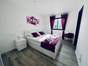 a bedroom with a large bed with purple pillows at A GIOIA DI CAMPA in Figari