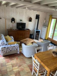 a living room with a couch and a table at Le Nid de Bercé in Jupilles