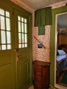 a room with a door and a bedroom with a bed at Trevligt Torp i vacker natur in Mellerud
