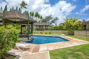 a backyard with a swimming pool and a gazebo at Spectacular golf course front in Kahuku