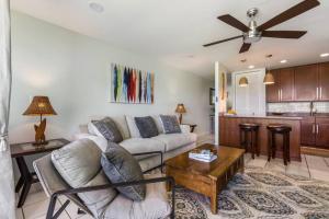 a living room with a couch and a table at Gorgeous One Bedroom golf course front in Kahuku