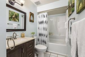 a bathroom with a sink and a toilet and a shower at Gorgeous One Bedroom golf course front in Kahuku +31 photos