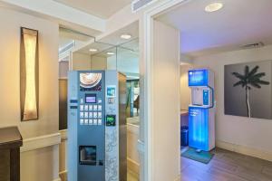 an atm machine in a room with a palm tree on the wall at Incredible Location FREE parking in Waikiki in Honolulu