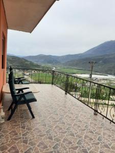 a balcony with benches and a view of the ocean at Guesthouse Lula 2 in Tepelenë