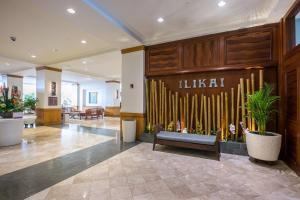 a lobby with a bench in the middle of a building at Ocean Front Amazing One bedroom condo in Honolulu +38 photos