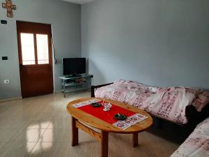 a living room with a couch and a coffee table at Guesthouse Lula 2 in Tepelenë