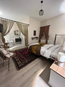 a bedroom with a bed and a living room at Ipekyolu Garden in Avanos