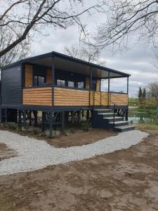 a rendering of a tiny house on a platform at GM House, mobile house near Kolpa river in Metlika