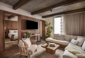 a living room with a couch and a tv at 1 Hotel Nashville in Nashville