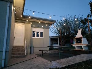 a patio with a table and a house with lights at House with pool and garden in Esmoriz near Porto in Esmoriz