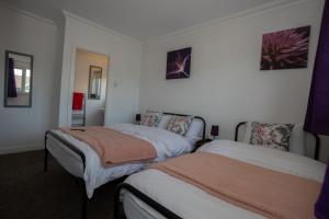 a bedroom with two beds in a room at Renfrew House in Bolton