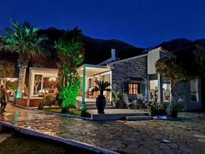 a house with a palm tree in front of it at Villa Gala in Balíon