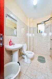a bathroom with a toilet and a sink at City view luxury Suites in Nairobi