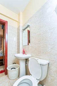 a bathroom with a toilet and a sink at City view luxury Suites in Nairobi