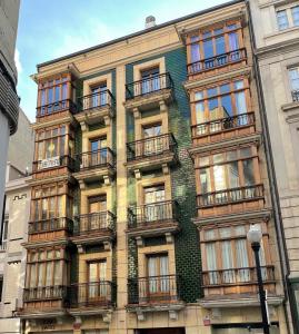 a building with balconies on the side of it at APARTAMENTO CARMEN in Gijón