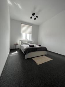 a white bedroom with a bed and a window at Cozy room between Kazimierz and the city center in Krakow