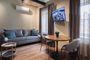 a living room with a table and a couch at Colonel Suites & Apartments in Rīga