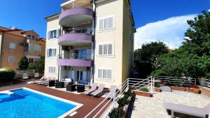 a building with a swimming pool next to a building at SEA VIEW- spacious apartment with shared pool in Split