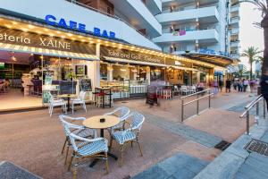 a table and chairs in front of a restaurant at Hotel Xaine Park in Lloret de Mar