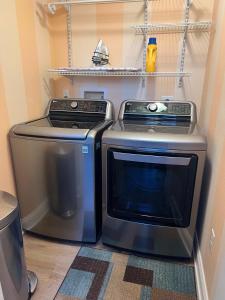 a kitchen with a stove and a washer and dryer at 4BD 3BR Pool Paradise 1 mile from Beach & Downtown in Saint Augustine
