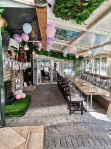 a dining room with tables and chairs and balloons at Hotel Elit in Devin