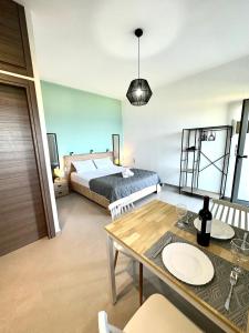 a bedroom with a bed and a table and a dining room at Brand new studio Sea View in Agia Pelagia