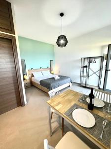 a bedroom with a bed and a table and a dining room at Studio Sea View in Agia Pelagia