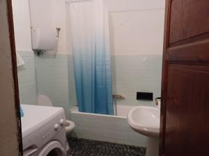 a bathroom with a sink and a toilet and a shower at Casa di Lavanda in Saturnia