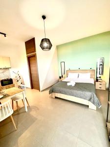 1 dormitorio con cama, mesa y escritorio en Brand new studio Sea View, en Agia Pelagia