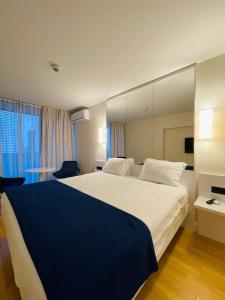 a bedroom with a large bed with a large mirror at ORBI CITY lux studio apartment in Batumi