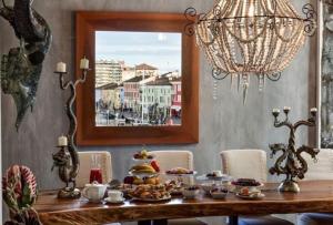 a dining room table with food on it at CasaDodici Boutique Hotel in Cesenatico