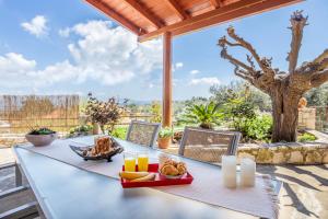 a table with a tray of food on a patio at The Morus House with Private pool in Melidhónion