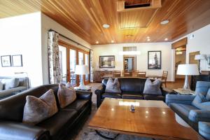 a living room with leather couches and a wooden ceiling at Stein Eriksen Lodge Deer Valley in Park City
