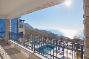 a balcony with a view of the ocean at Sunbreeze Delux Vilas in Budva
