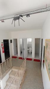 a large room with a staircase and a toilet at Albergaria Hostel in Fortaleza