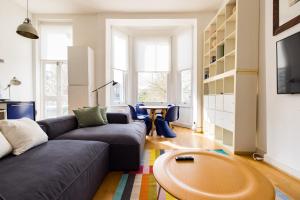 a living room with a couch and a table at Stylish & Spacious Notting Hill Loft in London