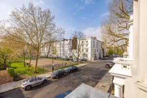 a view of a street with parked cars and buildings at Stylish & Spacious Notting Hill Loft in London