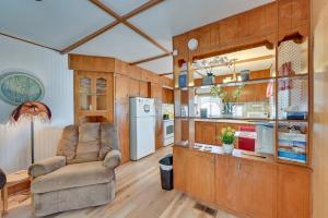 ein Wohnzimmer mit einem Stuhl und einem Kühlschrank in der Unterkunft Pet-Friendly Yuma Vacation Rental with Pool Access! in Yuma