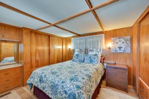 a bedroom with a bed in a room with wooden walls at Pet-Friendly Yuma Vacation Rental with Pool Access! in Yuma