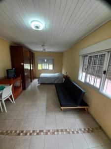 a bedroom with a bed and a couch in a room at Monoambiente con terraza cerca de todo in Corrientes