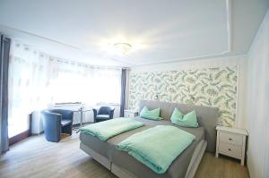 a bedroom with a bed and a table with chairs at Pension Belzer in Boppard