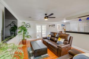 a living room with a couch and a table at Clearwater Vacation Home Rental with Tiki Bar! in Clearwater