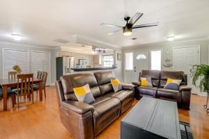 a living room with a leather couch and a table at Clearwater Vacation Home Rental with Tiki Bar! in Clearwater