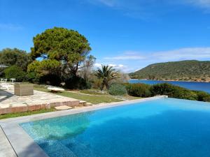 a swimming pool with a view of the water at Summer Villa in Porto Rafti in Porto Rafti