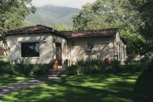 聖洛倫索的住宿－Rincon del Cerro，一座带草地庭院的白色小房子