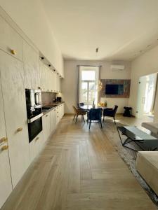 a living room with a kitchen and a table at Comfort Lux Design Apartment #Castle #2bedroom #freeparking in Budapest
